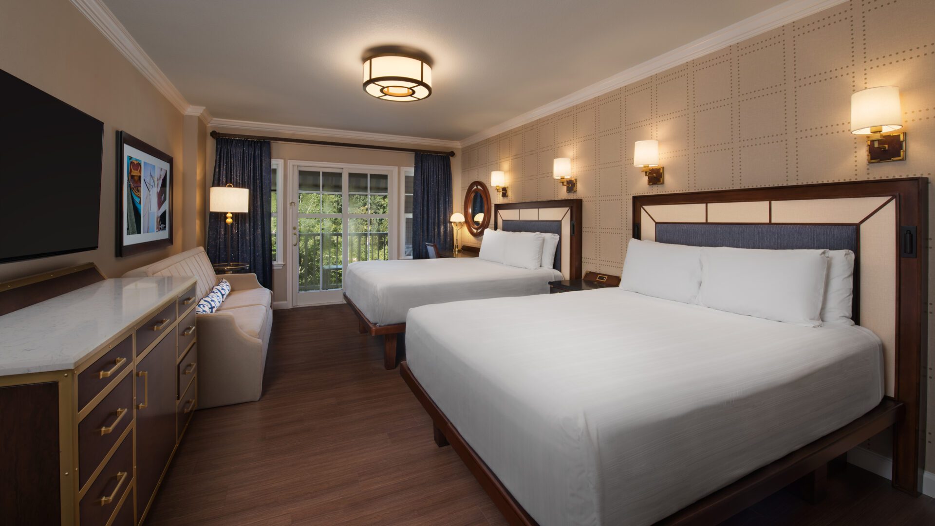 Disney Copyright Image Disney's Yacht Club Resort Interior A spacious hotel room features two queen beds, a flat-screen TV, modern lighting, and patio access through sliding glass doors.