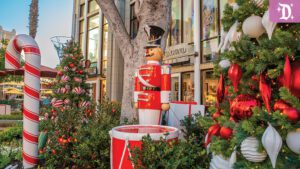 A festive scene featuring a red and white toy soldier, a large candy cane, and a decorated Christmas tree with ornaments.