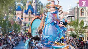 A colorful parade scene at a theme park featuring a float with a character resembling a famous mouse, surrounded by enchanted castle scenery.