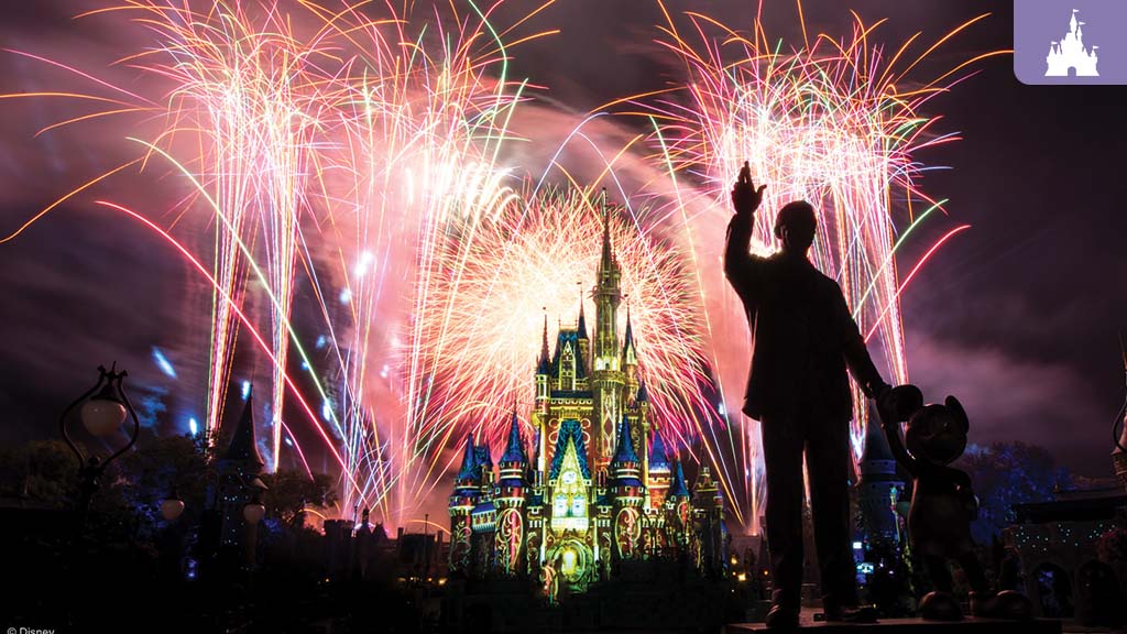 A silhouette of a person stands beside a statue, overlooking a castle illuminated by vibrant fireworks in the night sky.