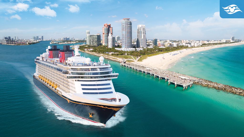 A cruise ship sails through turquoise waters near a sandy beach and a modern city skyline under a clear blue sky.