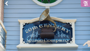 A decorative blue sign features the text "20th Century Music Company" with an antique gramophone design above it.