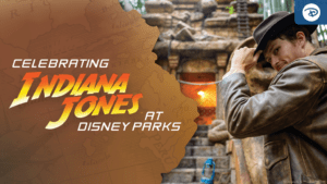 A man in a fedora stands near an ancient temple, with a glowing, fiery backdrop, promoting Indiana Jones at Disney Parks.