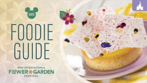 EPCOT Flower & Garden Festival Foodie Guide image featuring a floral-themed tart with a golden crust, yellow filling, and white chocolate topped with edible flowers.