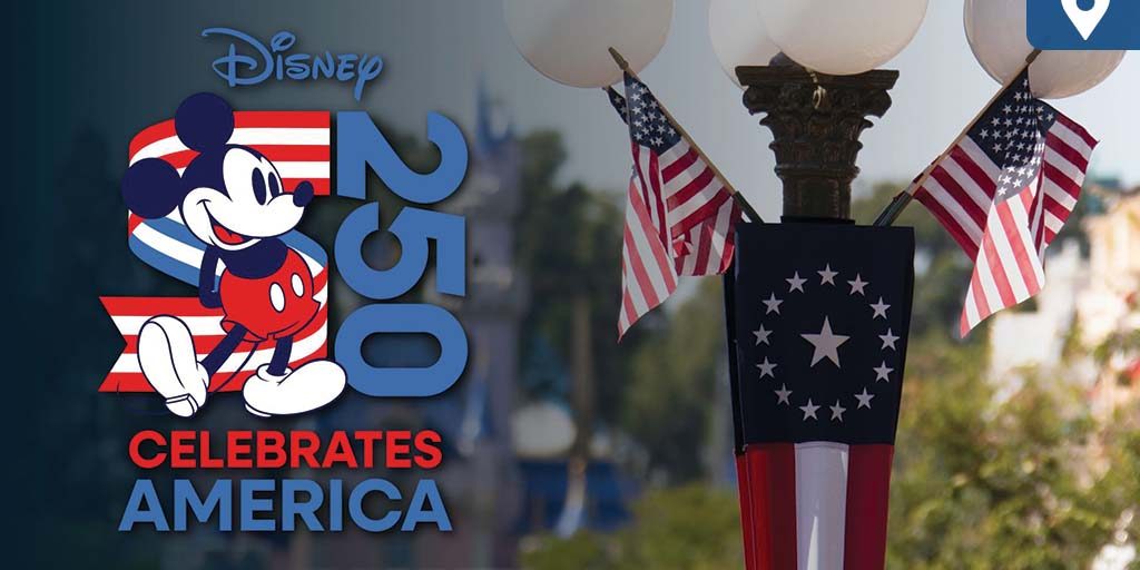 disney-celebrates-america Mickey Mouse stands beside a patriotic "250 Celebrates America" logo, with U.S. flags and colonial bunting decorating a lamp post in a Disney park.