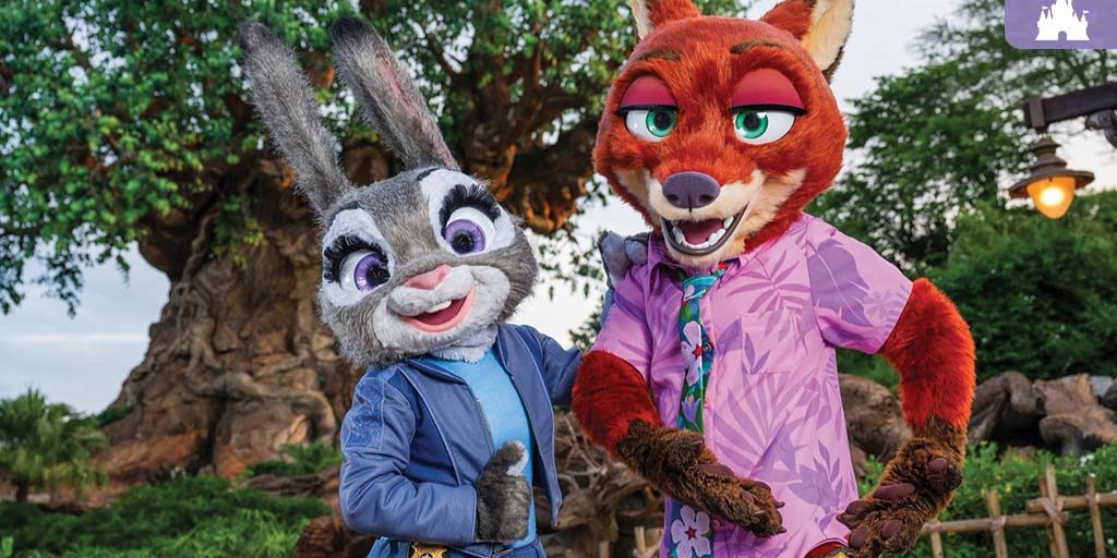 Judy Hopps and Nick Wilde pose in front of the Tree of Life at Disney’s Animal Kingdom, wearing their updated outfits from Zootopia 2.