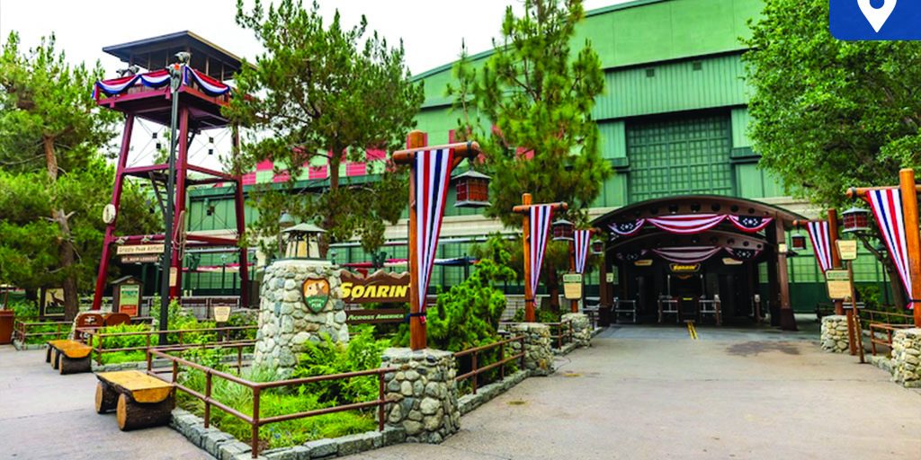 Soarin' Across America entrance at Disneyland Resort with patriotic bunting, wooden lookout tower, and signage leading to the attraction.