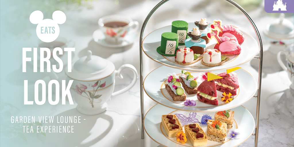 Three-tiered tray of Alice in Wonderland-themed afternoon tea treats at Garden View Lounge, with floral teacups and teapot in the background.