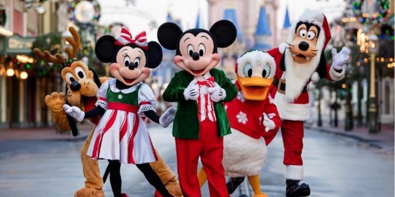 Mickey Mouse, Minnie Mouse, Pluto, Donald Duck, and Goofy in holiday outfits on Main Street U.S.A. at Magic Kingdom during Mickey's Very Merry Christmas Party