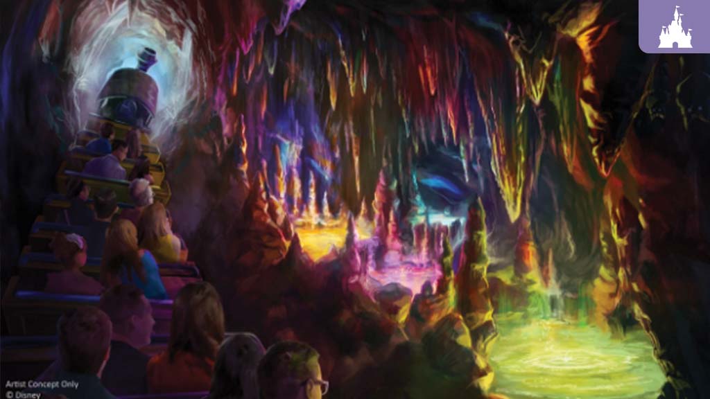 Colorful glowing cave scene from Big Thunder Mountain Railroad with riders on a train passing bright Rainbow Caverns and shimmering rock formations