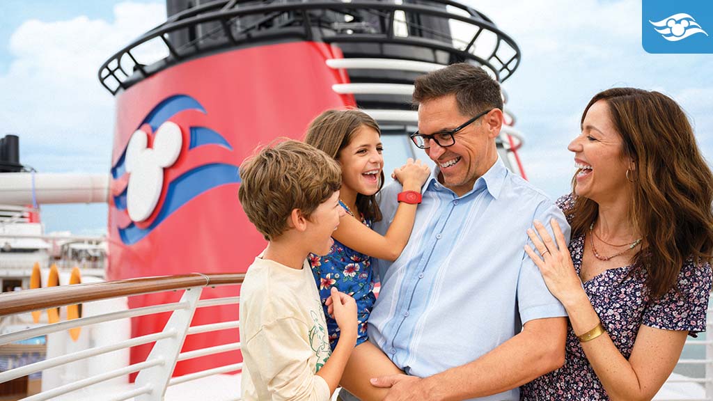 Smiling family enjoying time together on a Disney Cruise ship, with iconic red funnel and Mickey logo in the background.