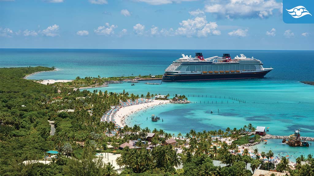 Aerial view of a tropical beach with a large cruise ship docked in turquoise waters, surrounded by lush greenery and palm trees.