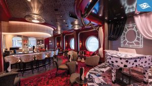 Stylish piano lounge aboard Disney Destiny featuring a Dalmatian-spotted piano, red and black décor, circular windows, and elegant bar seating.