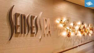 The interior of a spa featuring the sign "SENSES SPA" on a textured wall, accompanied by soft, ambient lighting and decorative elements.