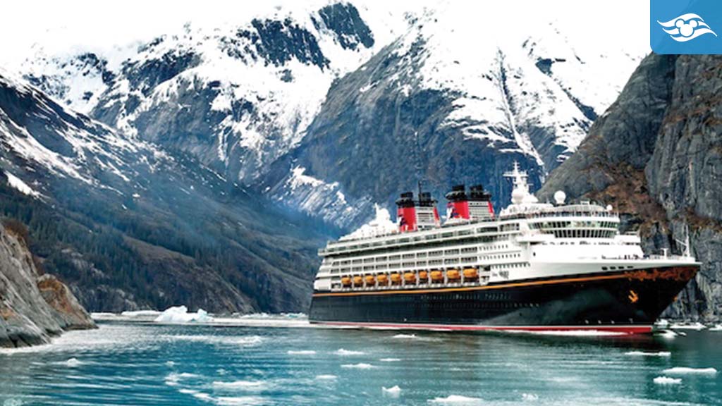 Disney Cruise Line ship sailing through a stunning Alaskan fjord, surrounded by snow-capped mountains and icy blue waters with floating ice chunks.