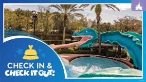 Colorful sea serpent waterslide at Disney’s Port Orleans French Quarter pool, with lush greenery and palm trees in the background.