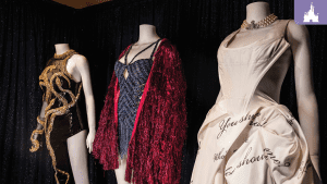 Taylor Swift Eras Tour costumes on display at Disney, featuring outfits from “reputation,” “Midnights,” and “THE TORTURED POETS DEPARTMENT.”