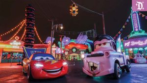 Lightning McQueen and Mater dressed in Halloween costumes in Radiator Screams at Disney California Adventure, surrounded by colorful neon lights and spooky decorations.