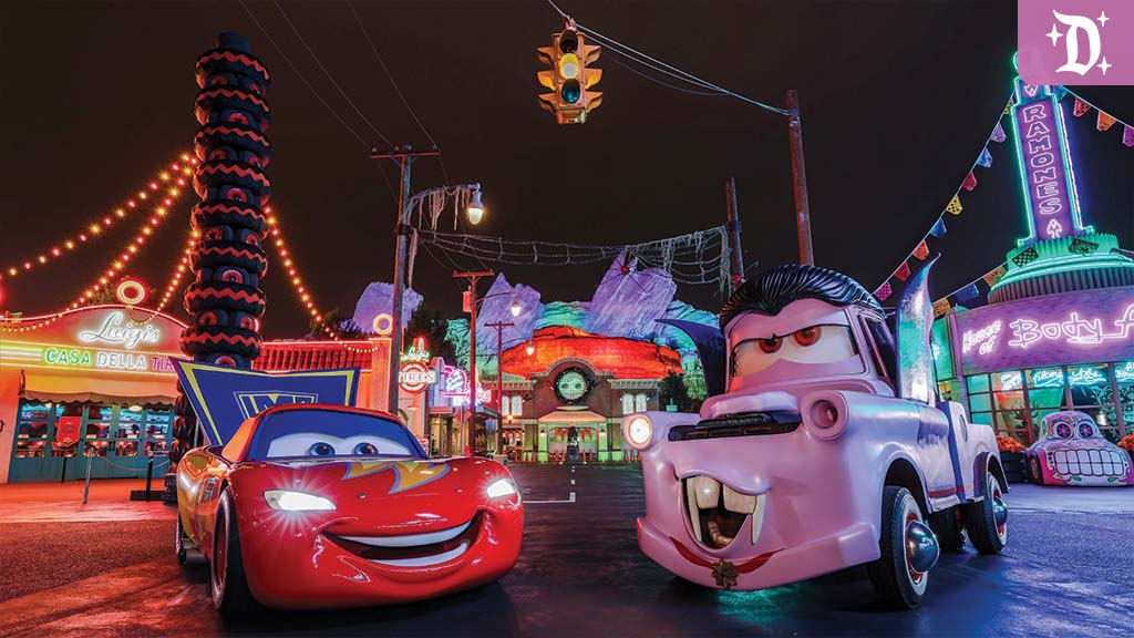 Lightning McQueen and Mater dressed in Halloween costumes in Radiator Screams at Disney California Adventure, surrounded by colorful neon lights and spooky decorations.