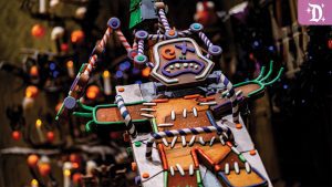 Close-up of a spooky gingerbread figure at Disneyland's Haunted Mansion Holiday, decorated with colorful candy details and eerie expressions.