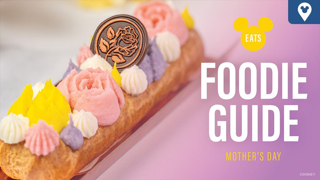 A beautifully decorated dessert featuring pastel flowers, a chocolate medallion, and the text "Foodie Guide Mother's Day" against a pink background.
