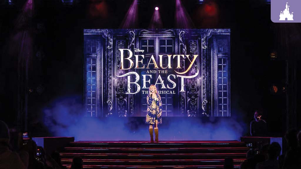 Performer sings on stage at EPCOT with a dramatic backdrop displaying “Beauty and the Beast: The Musical.”