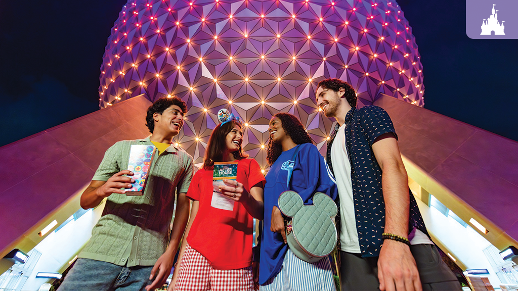 Four friends stand beneath a lit geodesic sphere, holding tickets and a snack box, smiling and talking at night.