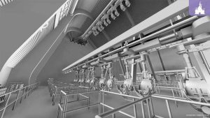 Concept art of a suspended coaster load area featuring hanging ride vehicles on a track, with metal railings and queue lines below in a large industrial-style space.