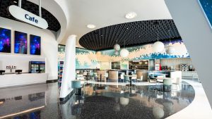Modern Cosmos Cafe with a galaxy-themed design, round light fixtures, and various seating areas for casual dining.