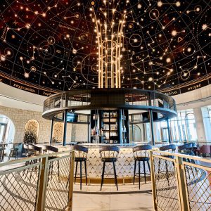 Stunning circular bar at Universal Helios Grand Hotel, with constellation-themed ceiling and dramatic lighting.