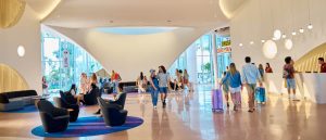 Guests check in and relax in the spacious, modern lobby of Universal Terra Luna Resort, with curved architecture and lounge seating.