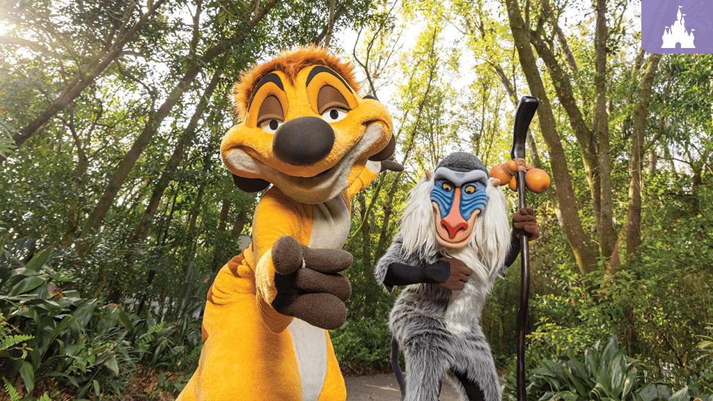 Two animated characters stand in a lush green forest: a cheerful yellow character with big eyes and a wise, older character holding a staff.