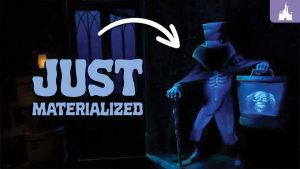 A ghostly figure in a top hat stands by a doorway, holding a bucket. The caption reads "JUST MATERIALIZED" with an arrow pointing to the figure.