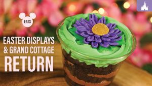 A close-up of a decorative dessert in a cup, featuring green frosting and a purple flower, against a floral background. Text highlights Easter themes.