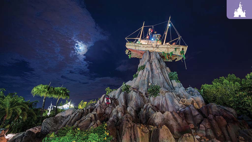 A wooden boat perched atop a rocky peak under a moonlit sky, surrounded by lush greenery.